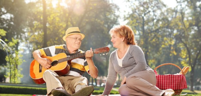 Man serenading his partner at the park