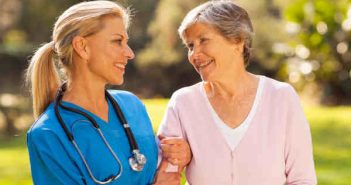 senior woman smiling with her nurse