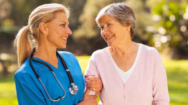 senior woman smiling with her nurse