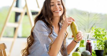 Beautiful happy woman sitting with healthy drinks