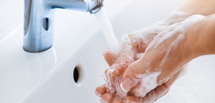 Woman use soap and hand washing on the water tap