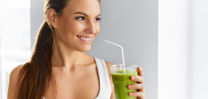 woman drinking fresh green vegetable shake for detox