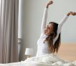 Happy woman in white stretching